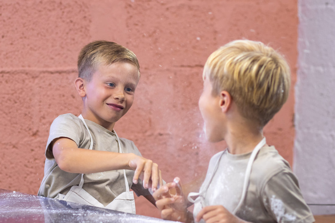 two young boys playing with flour