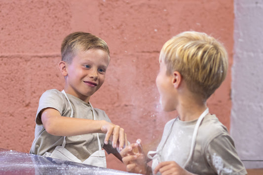 two young boys playing with flour