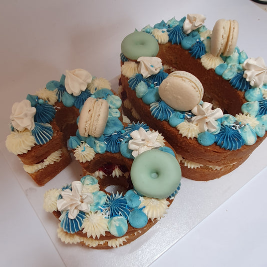 cake in a 30 shape with blue buttercream decorations