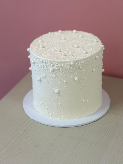 The Pearl celebration cake with textured buttercream and floral details